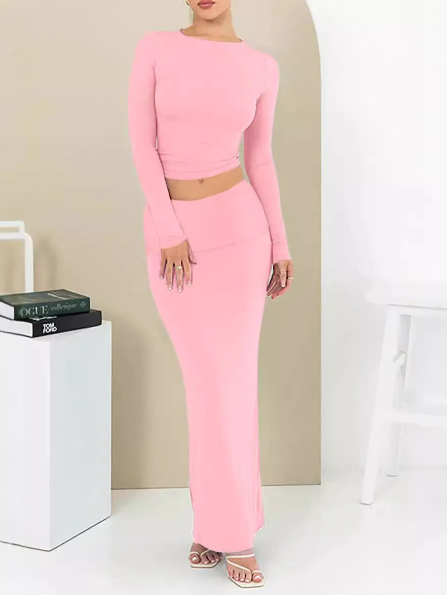 Women's black slim fit two-piece suit set with three-quarter sleeve top and long skirt on a model.