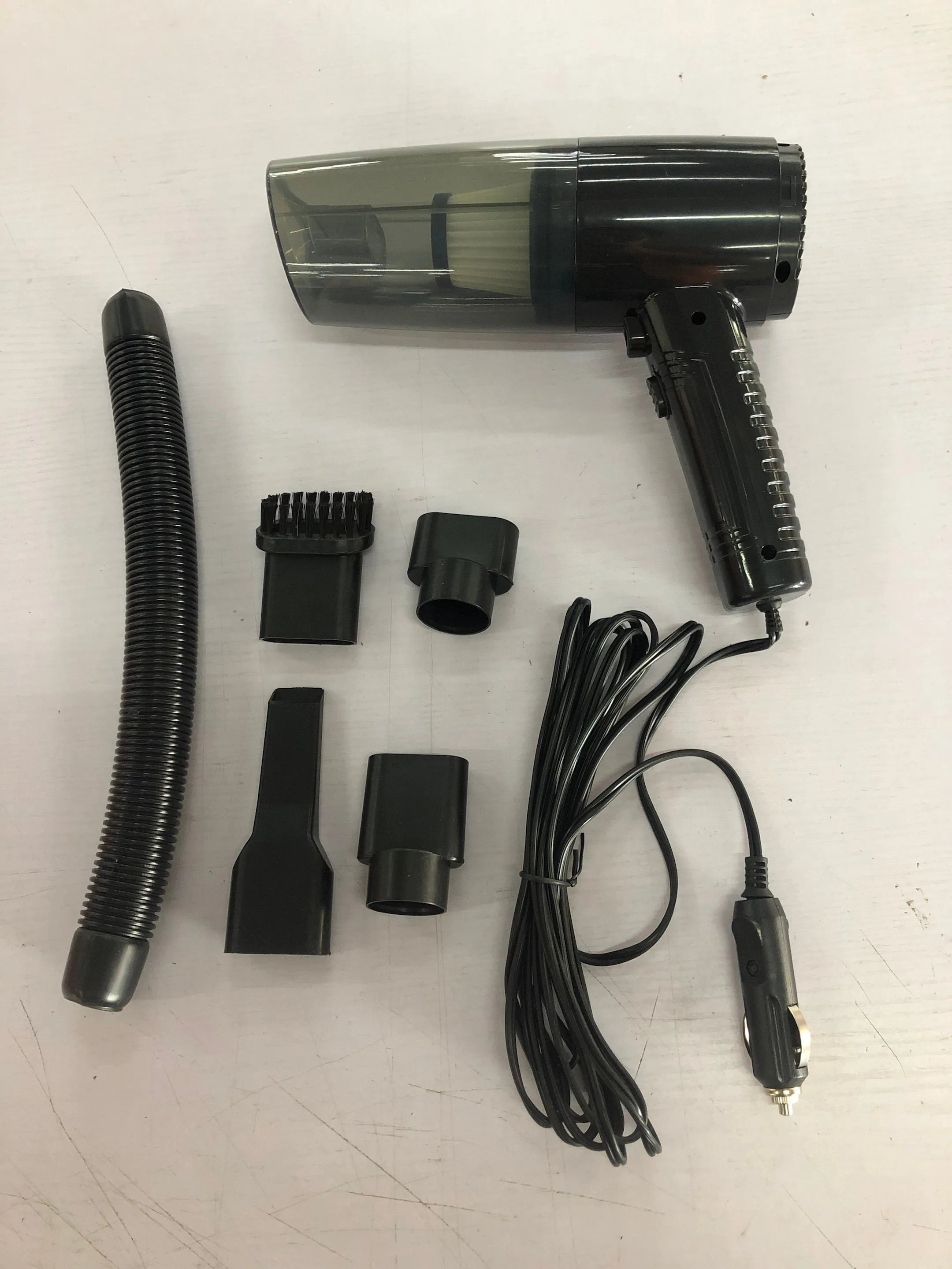 Car vacuum cleaner with black ABS shell and multiple suction attachments displayed with 5 metre power cord