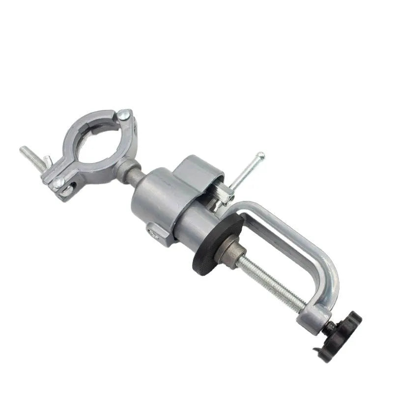 Small clamp-on bench vise with a 360-degree rotating tungsten steel head on a workbench edge.