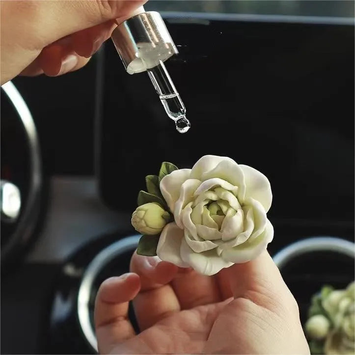 Jasmine scented solid gypsum car air vent diffuser in off white or green.