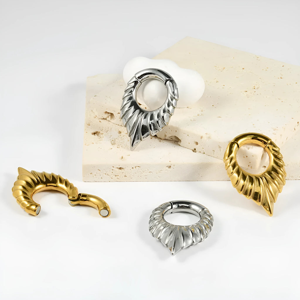 Stainless steel drop-shaped auricle ear extender with round hanging egg detail.