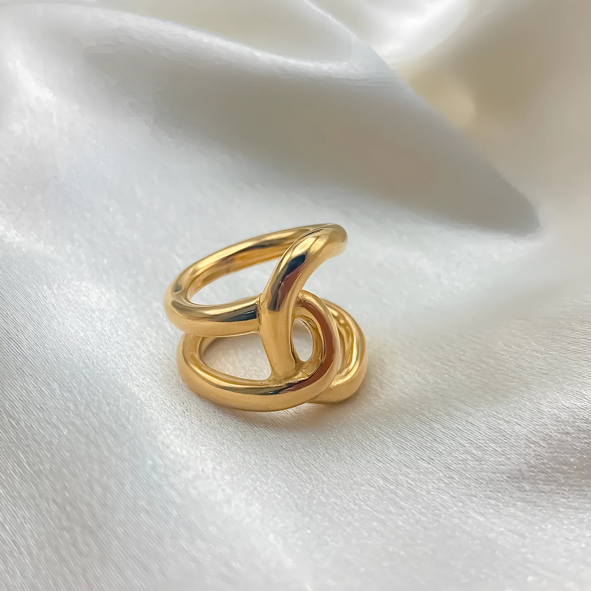 Geometric knotted open ring in stainless steel showing U-shape design and adjustable sizing