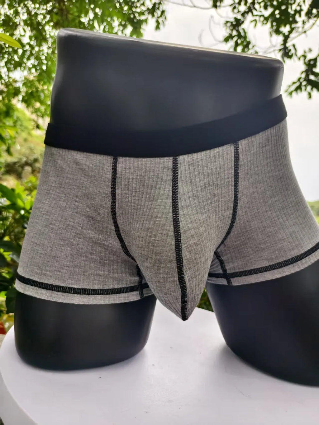 Solid colour men's boxer shorts in breathable fibre fabric, shown in Army Green.