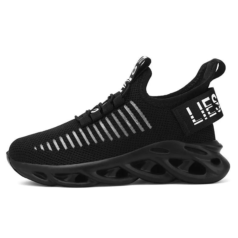 Children's black Velcro sneakers with fabric upper and textured EVA sole on a white background.