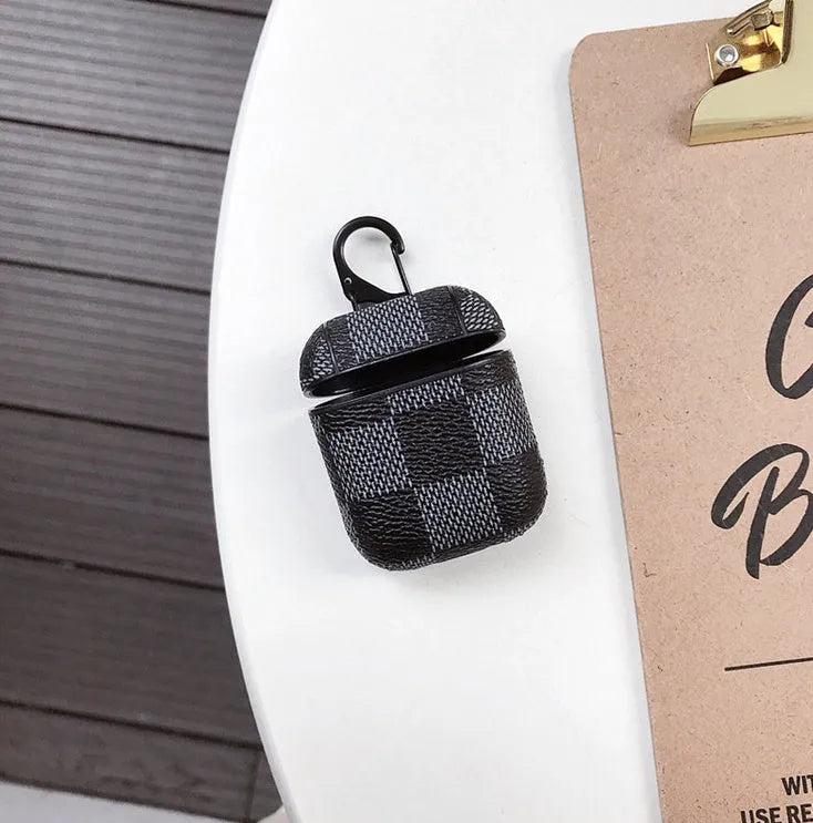 Hard plastic protective case for a wireless Bluetooth headset with an anti-lost hook, shown in a grid pattern.