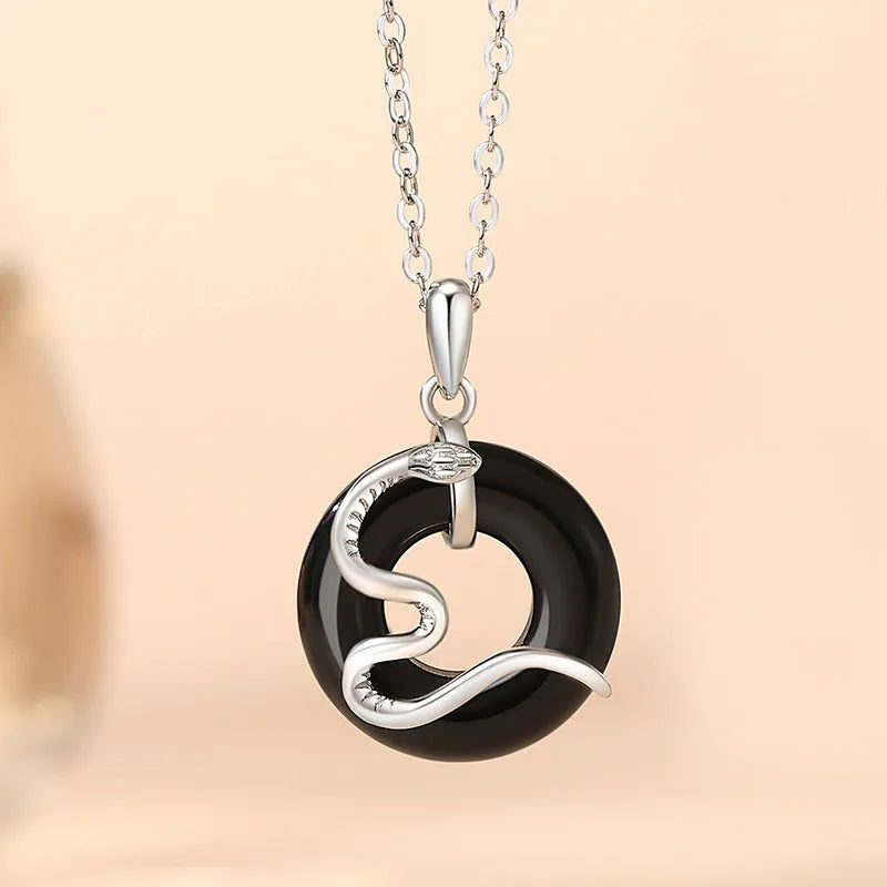925 sterling silver snake couple necklace with Peace buckle on black background