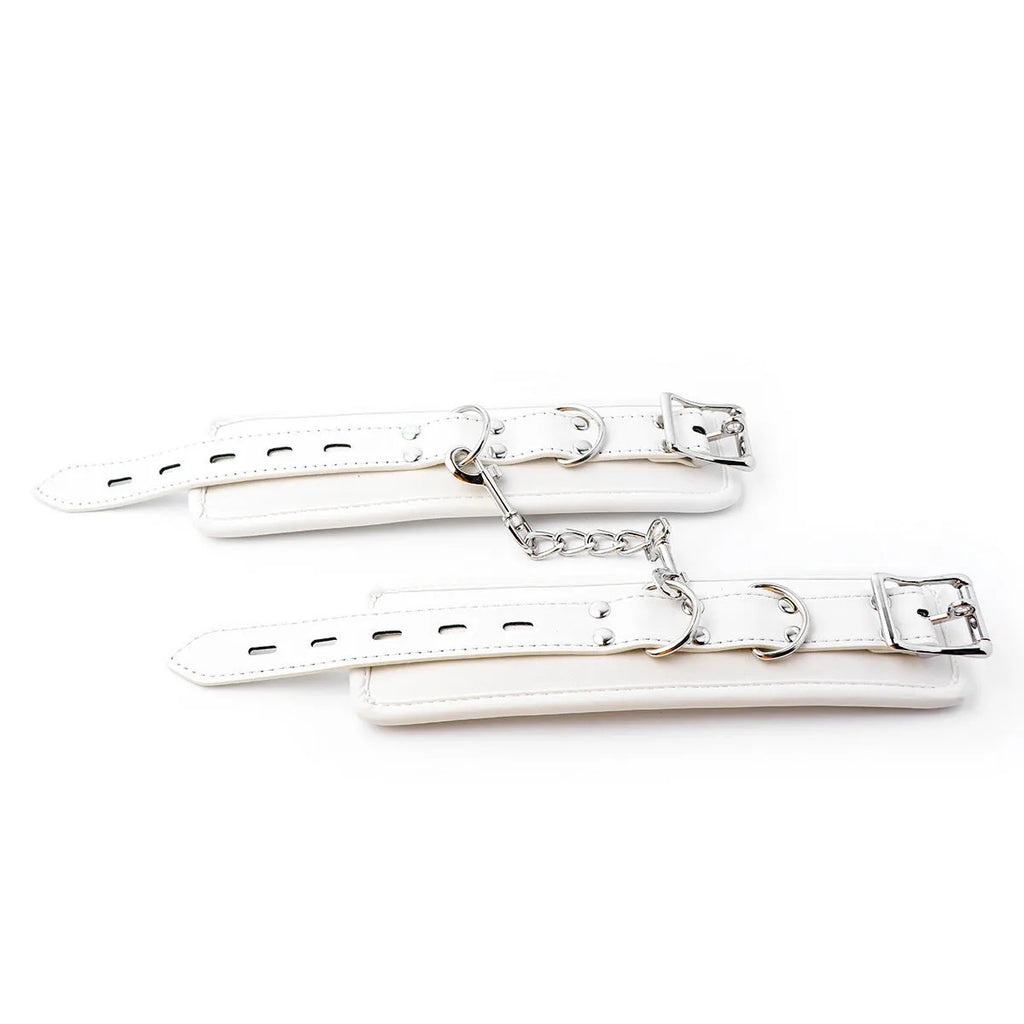 White PU sponge bondage set showing soft handcuffs, an ankle cuff, and a neck restraint.