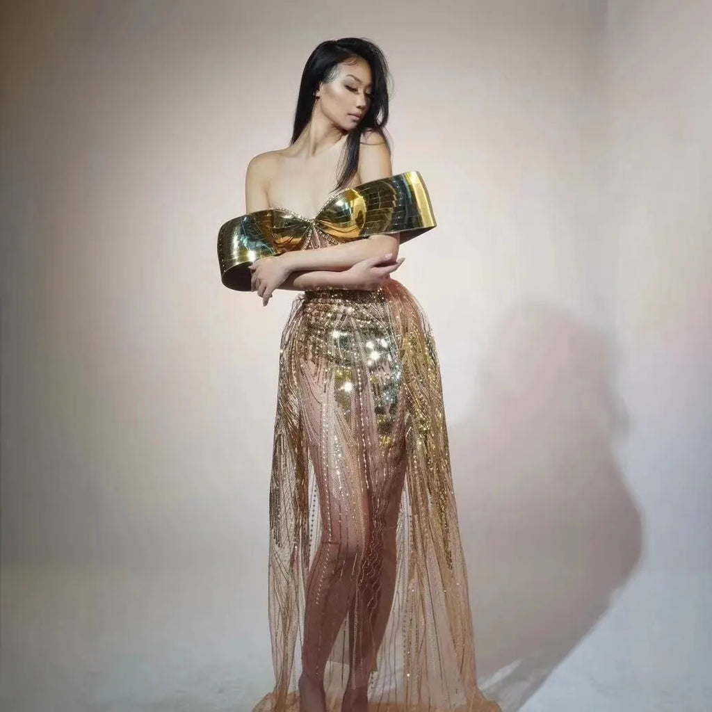 Gold strapless sequined evening dress with a high split tulle skirt.