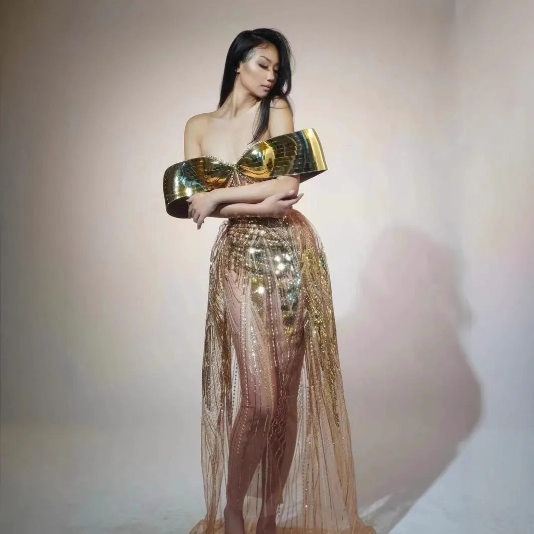 Gold strapless sequined evening dress with a high split tulle skirt.