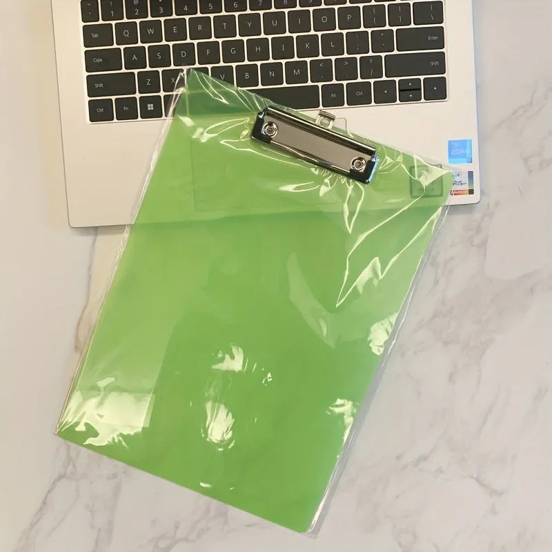 Transparent A4 writing board pad with metal clip holding paper, shown in blue colour variant.