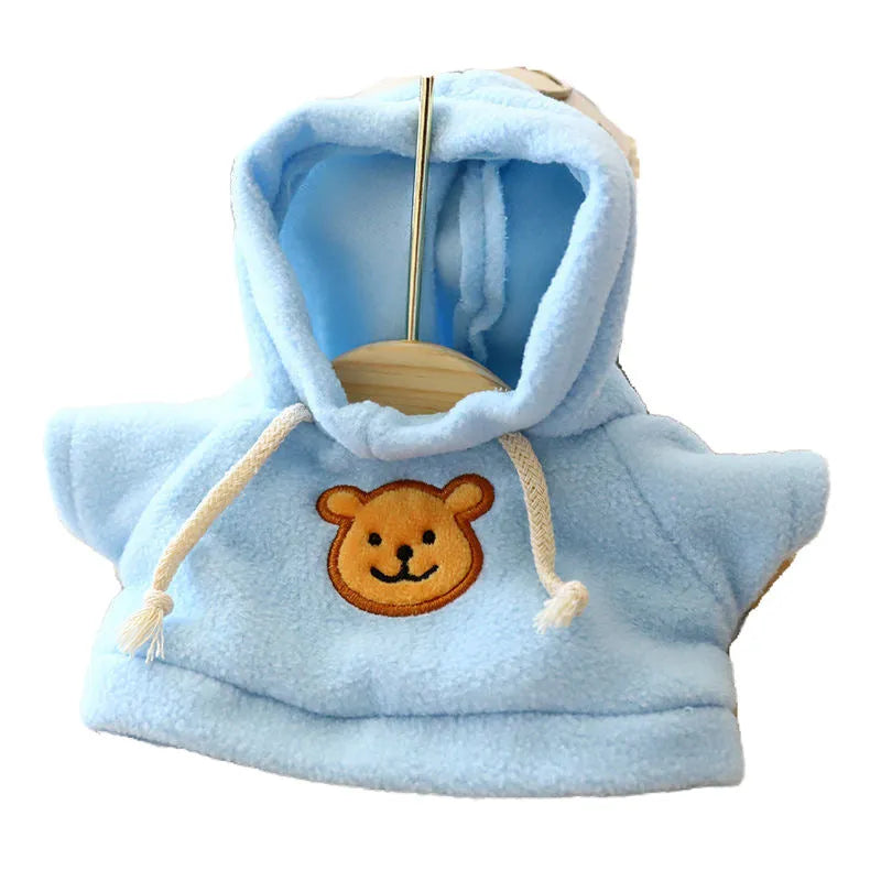 A small dog wearing a blue cloth hoodie sweater from the range of six available colours.