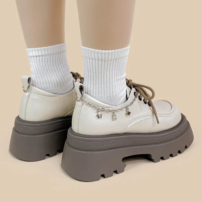 White platform Mary Jane shoes with chunky heel and round toe, front lace-up design