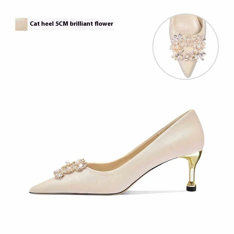 Rhinestone decorated pointed-toe bridal high heels on a white background.