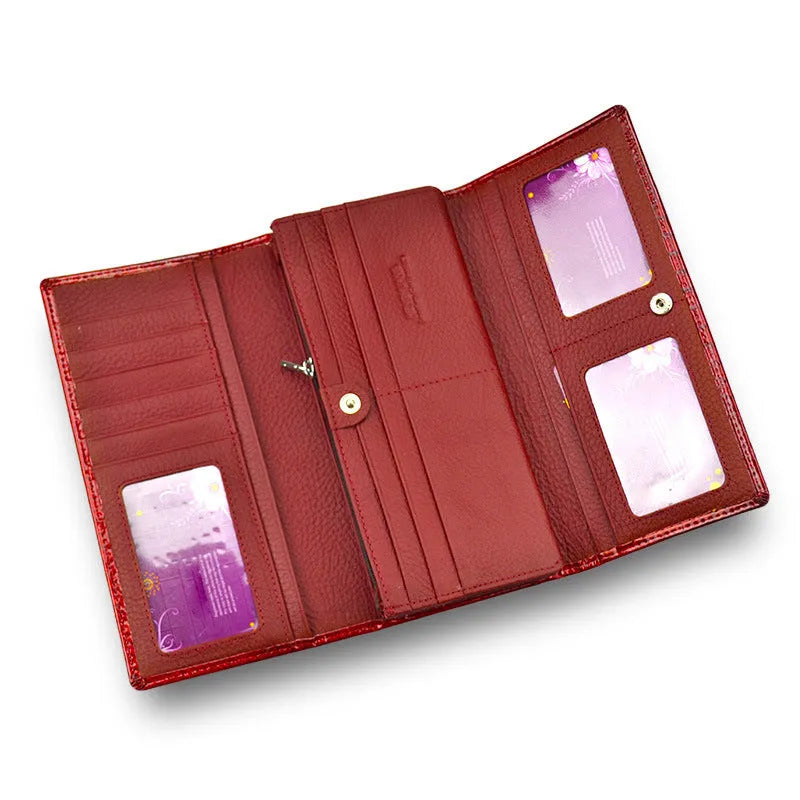 Women's red leather coin purse with a textured crocodile pattern, shown open to reveal pigskin lining.