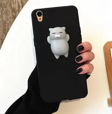 Soft silicone TPU iPhone case with a raised 3D cartoon cat design, shown in various colours.