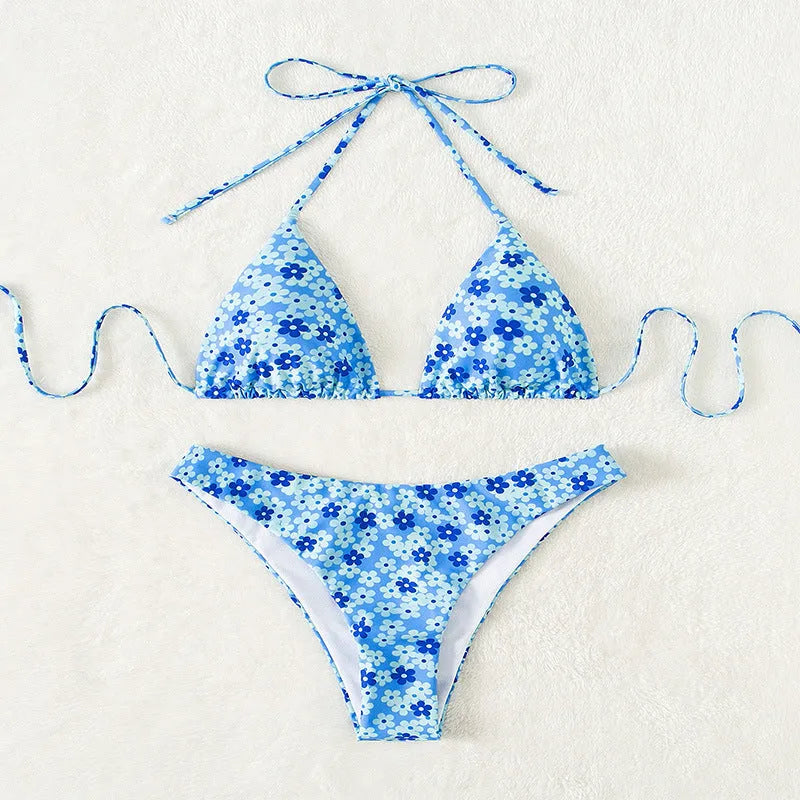 Blue printed women's swimsuit set with lace-up halter neck top and high-waisted side-split shorts.