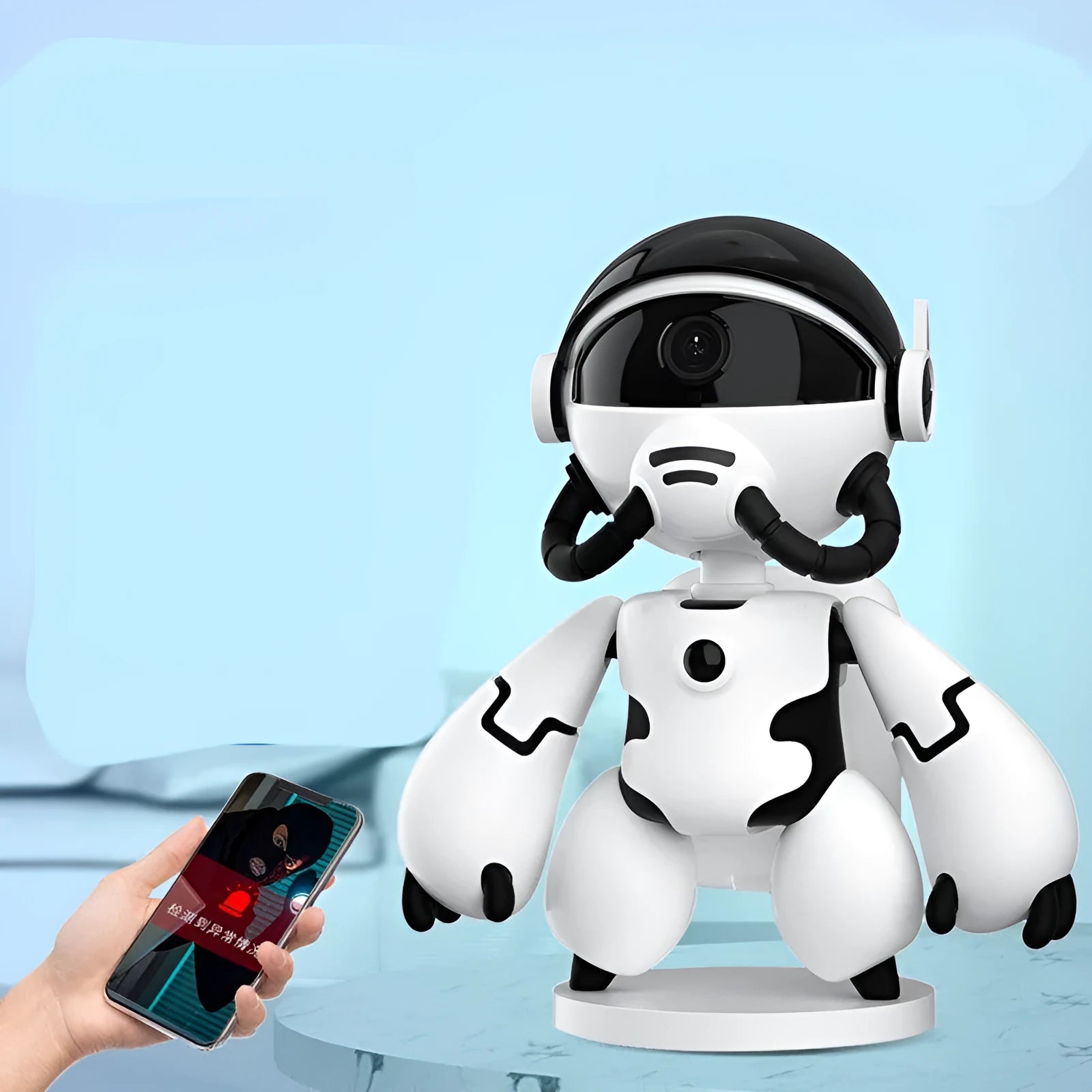 White or black wireless indoor security camera with a detachable base, shown on a shelf for home monitoring.