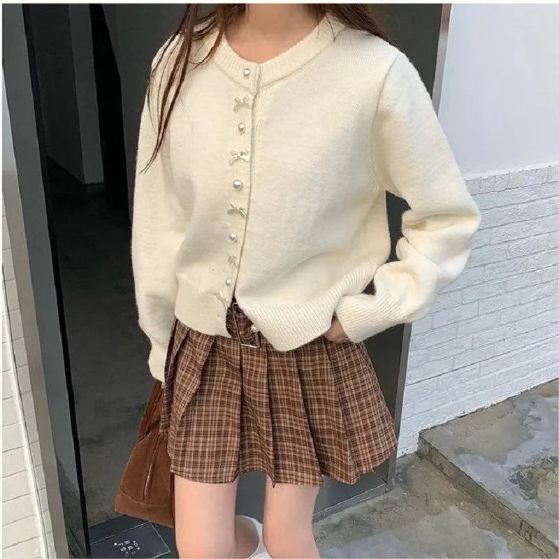 Women's acrylic cashmere cardigan sweater with bow and pearl button detail in nine colour options
