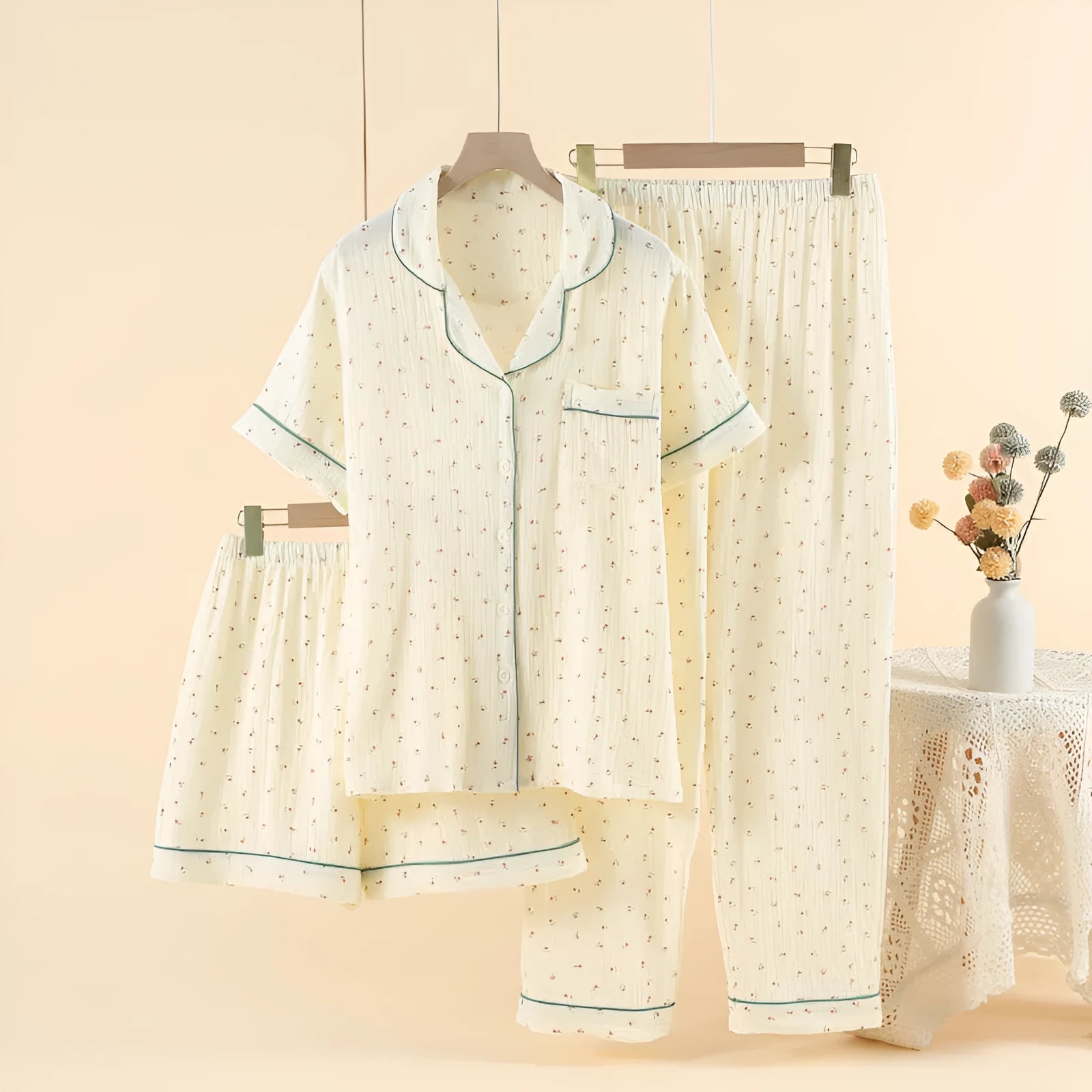 Women's cotton three-piece pyjama set in Pastoral Curcuma colour, showing lapel top with three-quarter sleeves and full-length trousers.