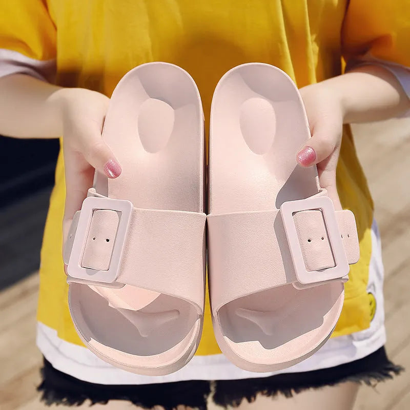 Women's grey blue buckle slippers with a flip-flop design and soft EVA sole on a white background