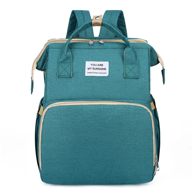 Portable folding crib mummy bag in nylon with curved shoulder strap and USB interface
