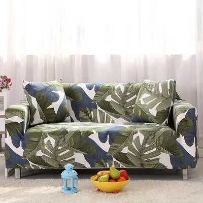 Geometric abstract printed stretch sofa slipcover covering a three-seater sofa with matching cushion covers.