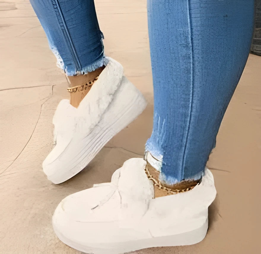Women's white cotton house slippers with a round toe and non-slip rubber sole.
