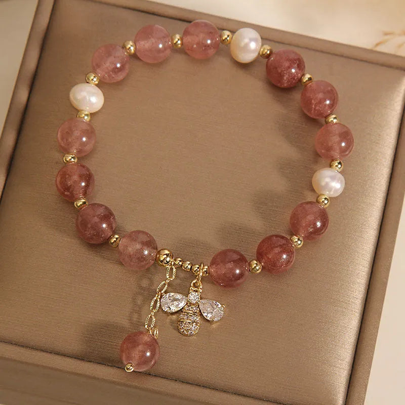 Women's strawberry quartz and freshwater pearl bracelet with zircon bee charm in Japanese-Korean jewellery style