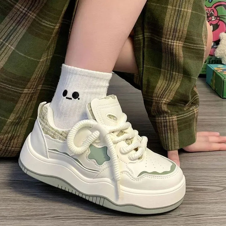 Women's green platform sneakers with patent leather details and rubber sole