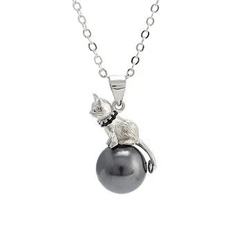 Close-up of a sterling silver cat silhouette pendant on a delicate silver chain.