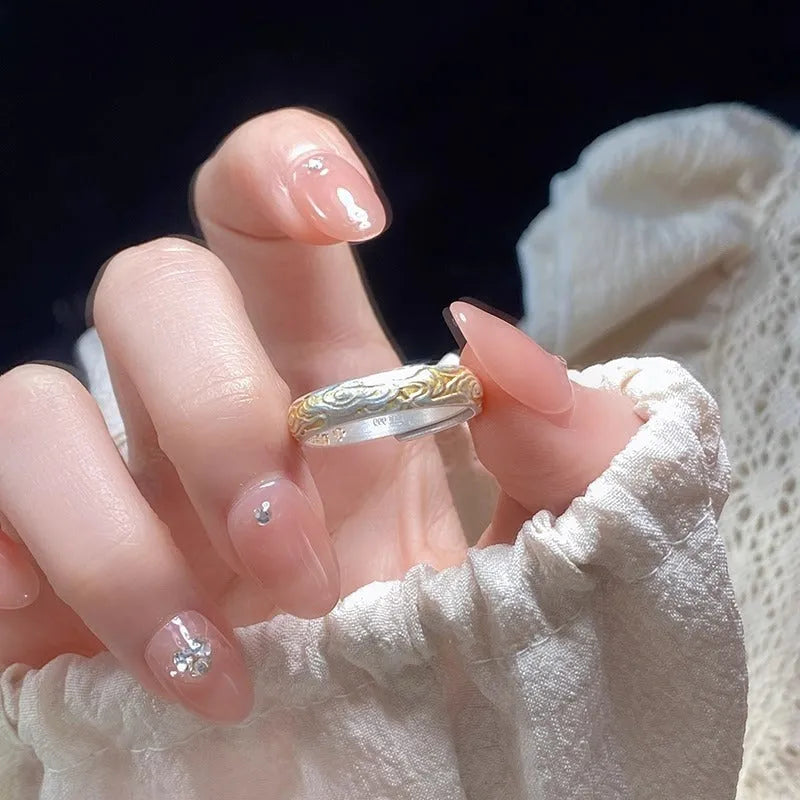 Geometric Xiangyun pattern open-mouth ring with silver and gold electroplated finish on white copper.
