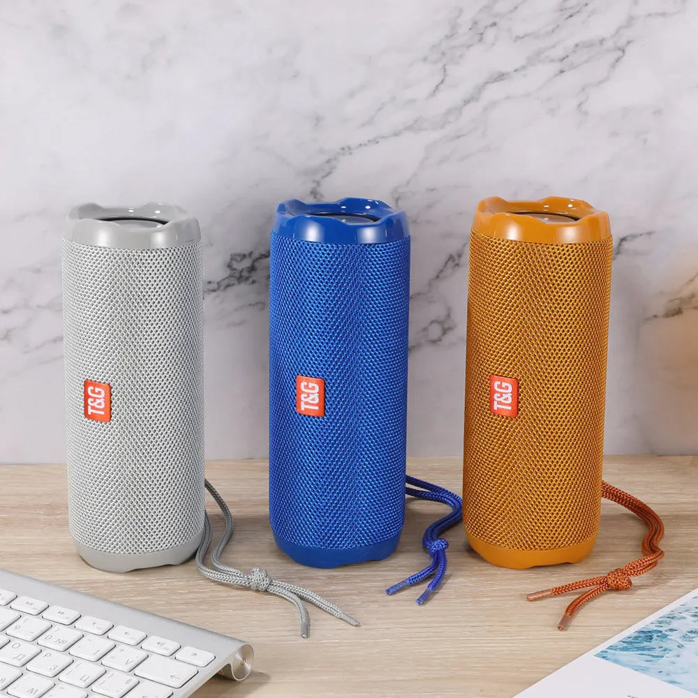 Fabric-covered portable Bluetooth speaker in multiple colours showing card holder slot.