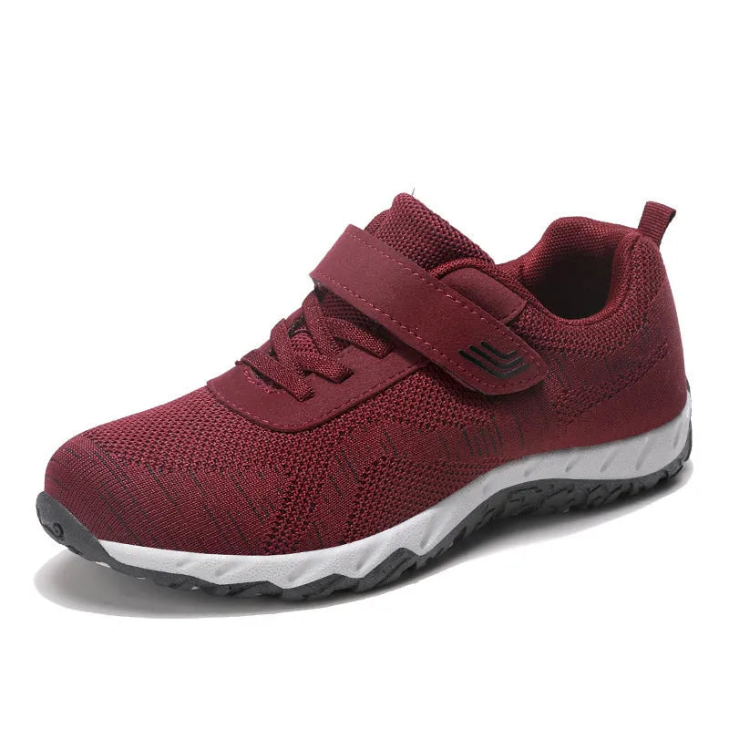 Women's low-top wedge sneaker in grey purple with mesh upper and Velcro strap.