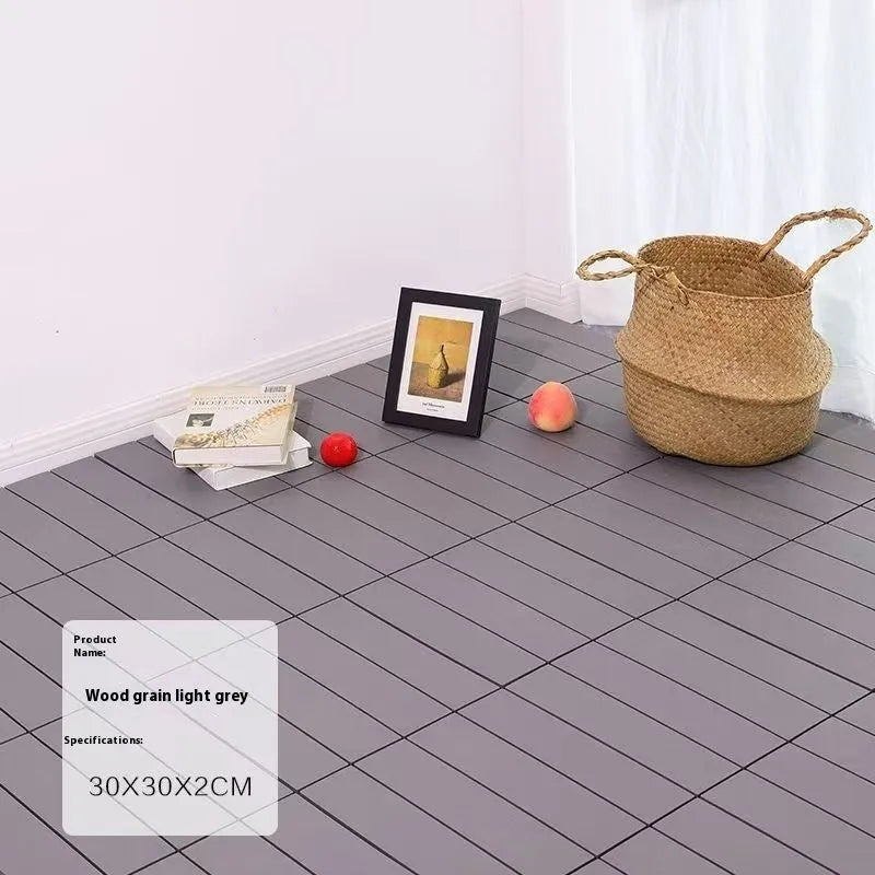 Pack of ten wood grain plastic interlocking floor tiles showing splicing edges.