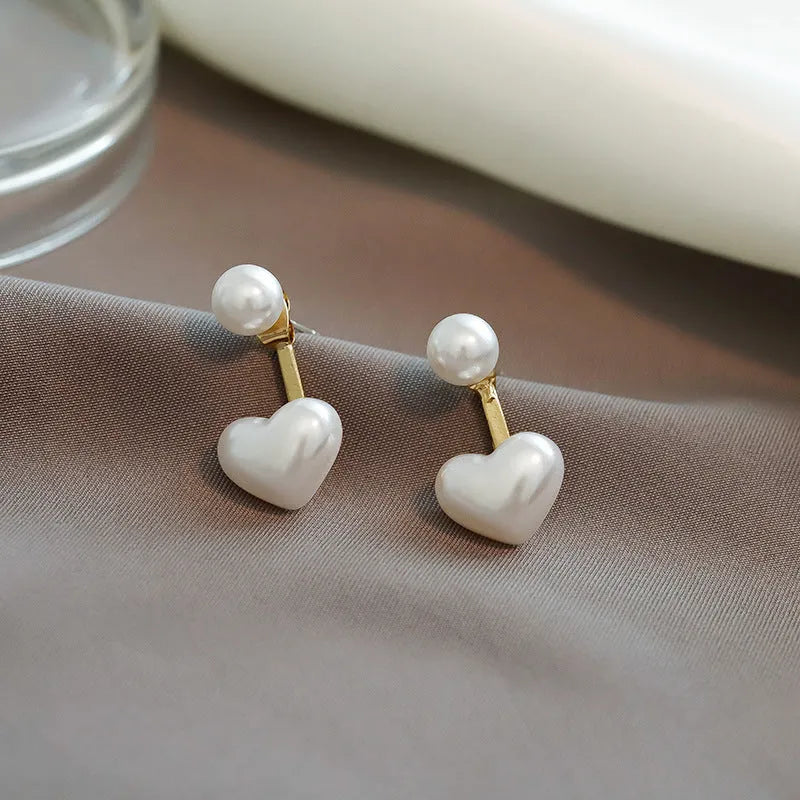Women's heart-shaped pearl stud earrings with alloy inlaid gems and an electroplated finish.