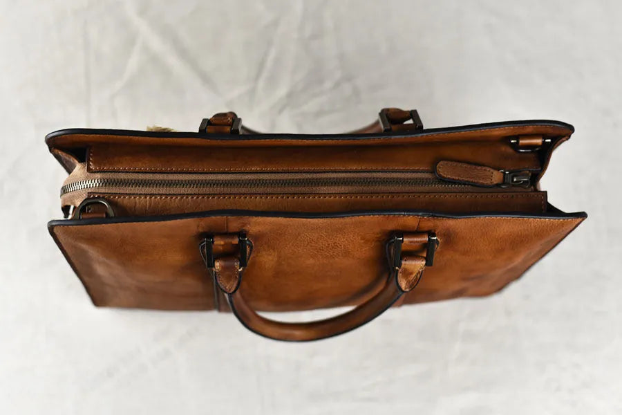 Men's brown leather retro horizontal business handbag with zipper opening.
