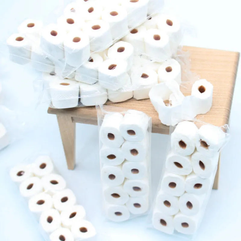 Small paper model of a tissue roll for dollhouse play, measuring 30mm by 15mm by 80mm.