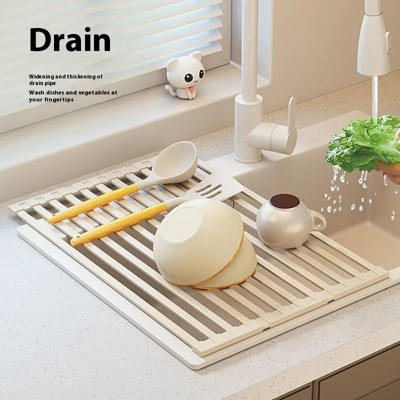 Milky white foldable stainless steel kitchen draining rack next to a sink.