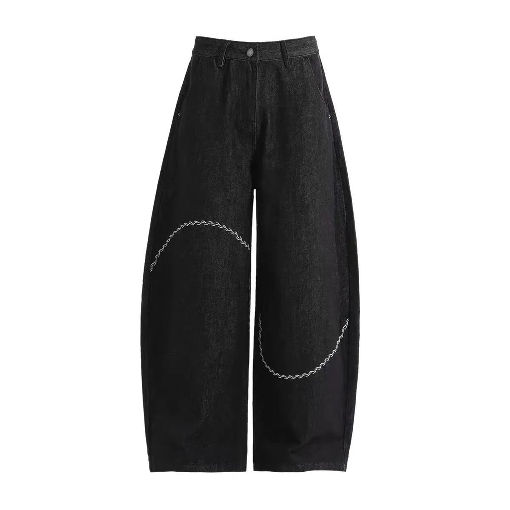 Black straight-leg denim trousers with a mid-waist and zip fly on a mannequin.