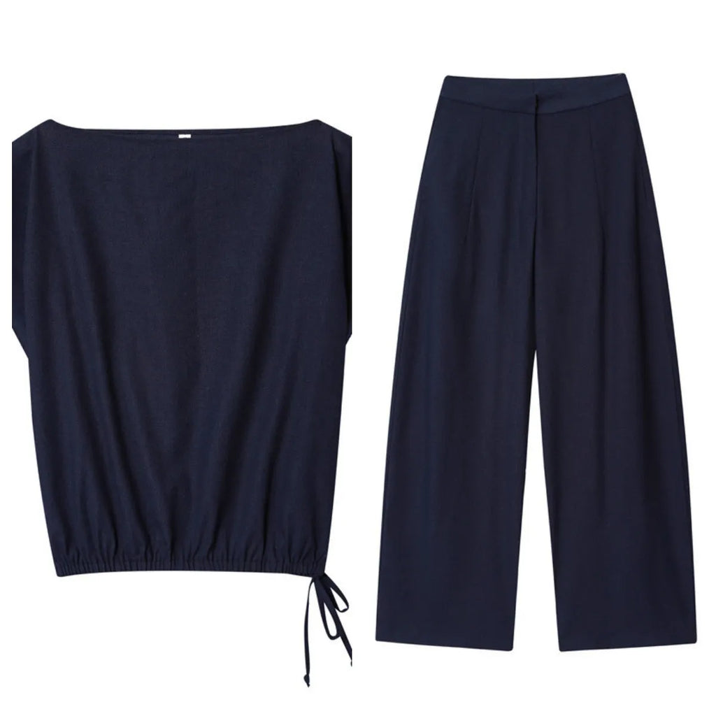 Women's linen blend two-piece set showing off-neck blouse with flounced sleeves and wide leg trousers