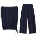 Women's linen blend two-piece set showing off-neck blouse with flounced sleeves and wide leg trousers
