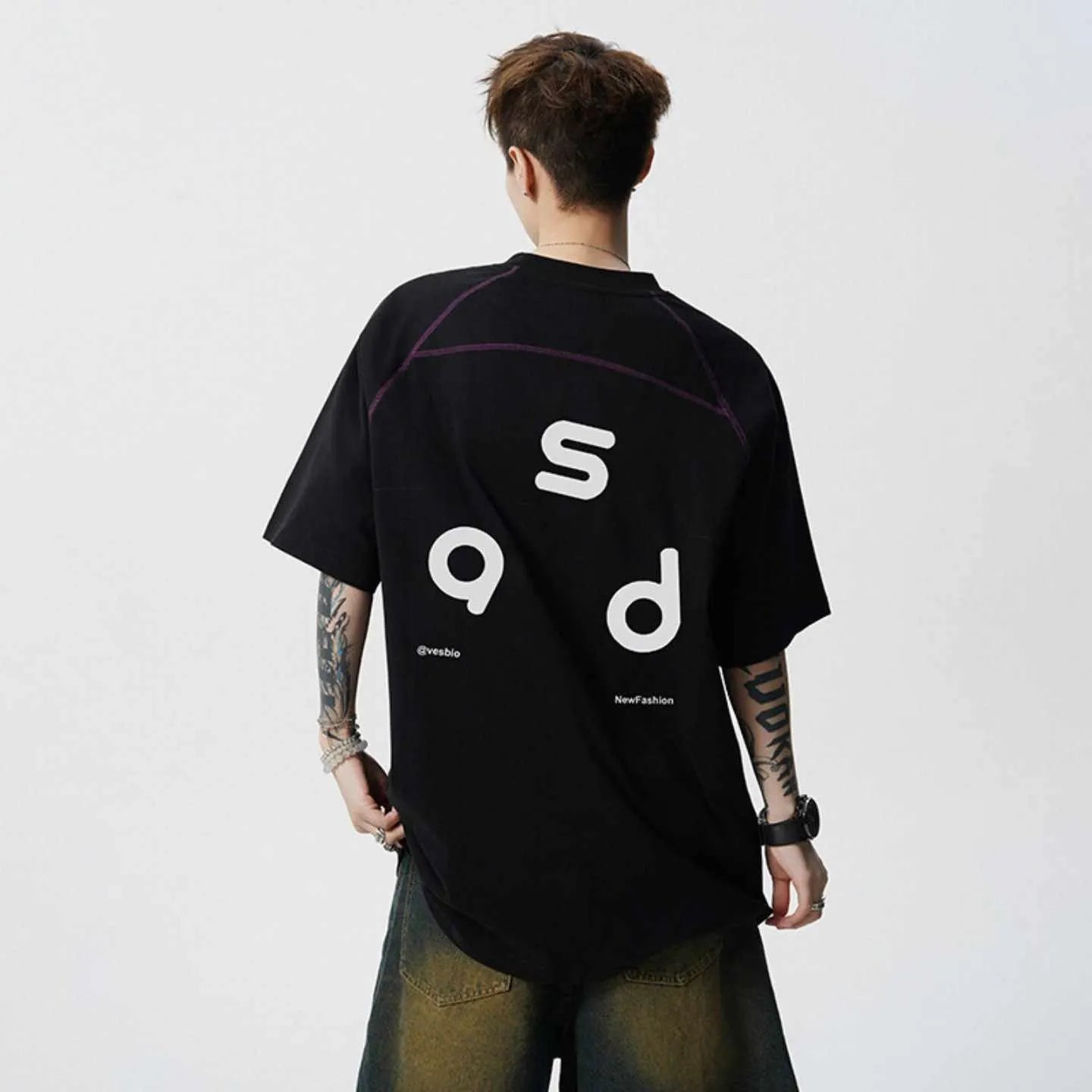 Loose fit black cotton t-shirt with a white letter print design on the front.