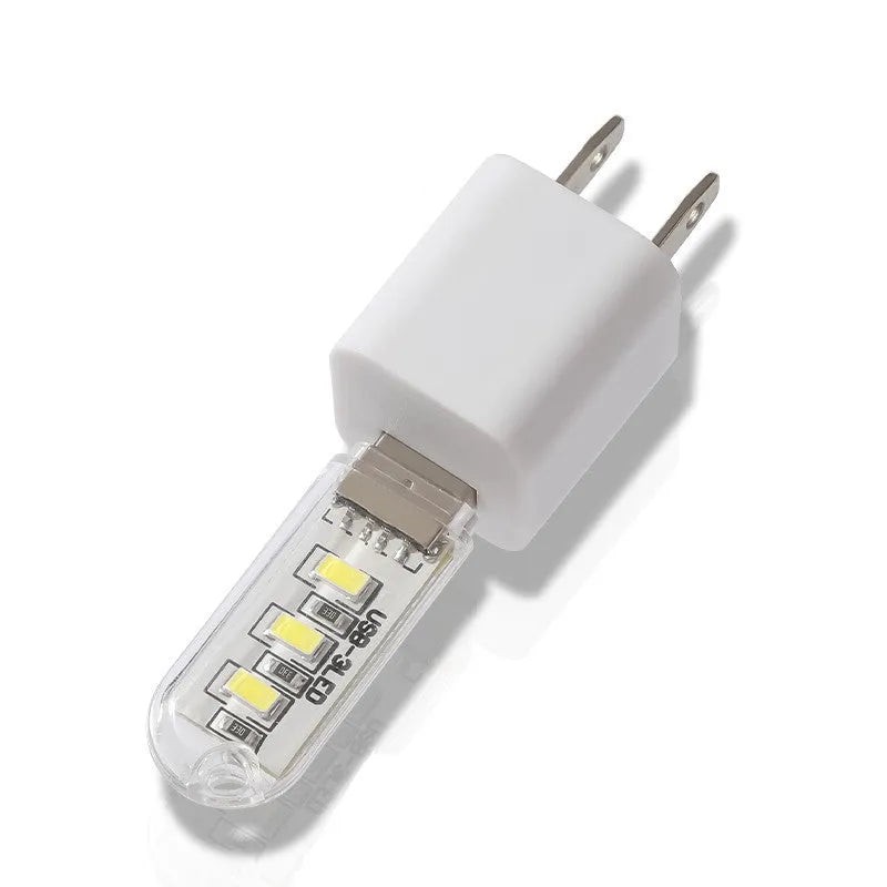 Small white USB-powered LED baby night light on a table