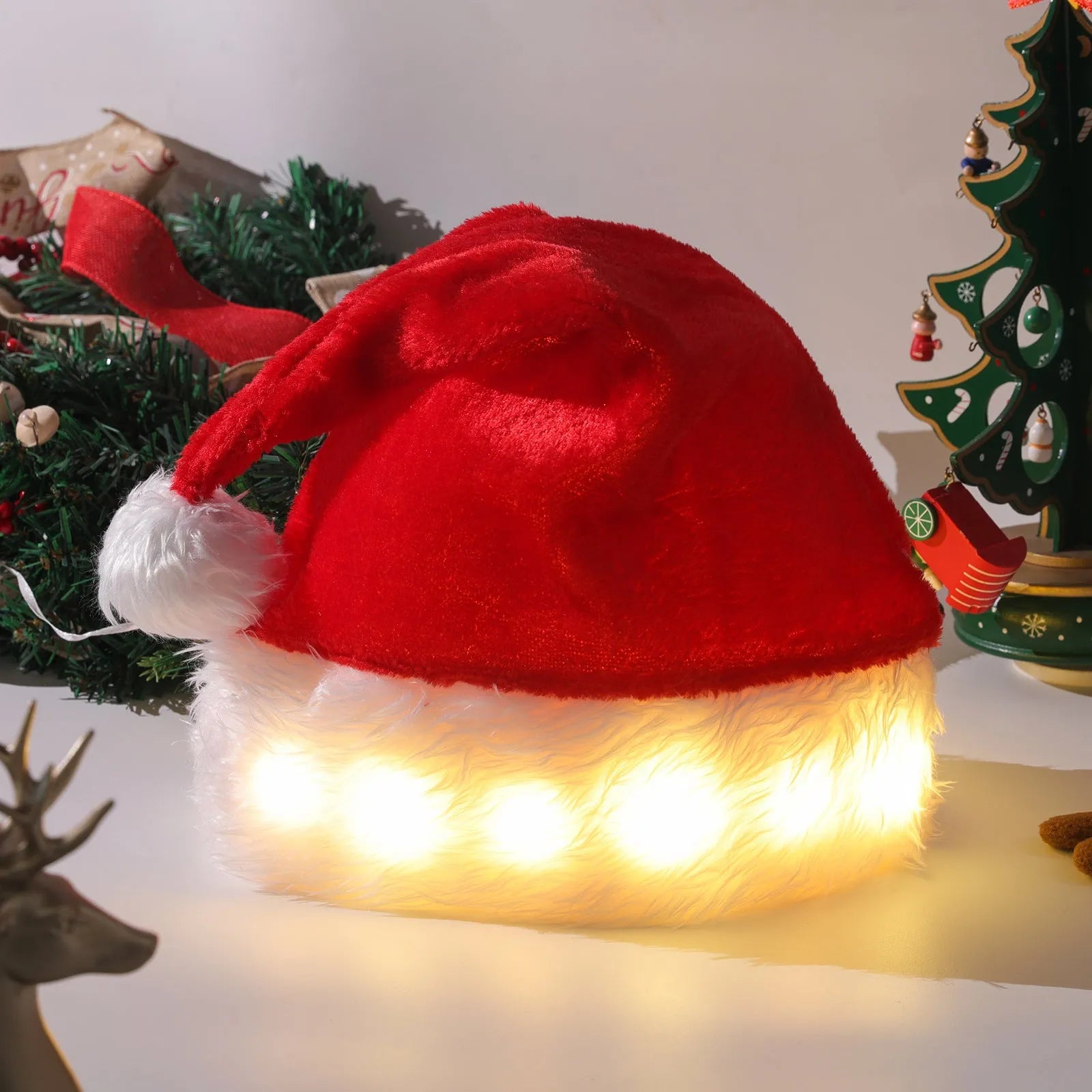 Red and white plush Santa hat with illuminated multi-colour LED lights around the base and a white pom-pom on top.