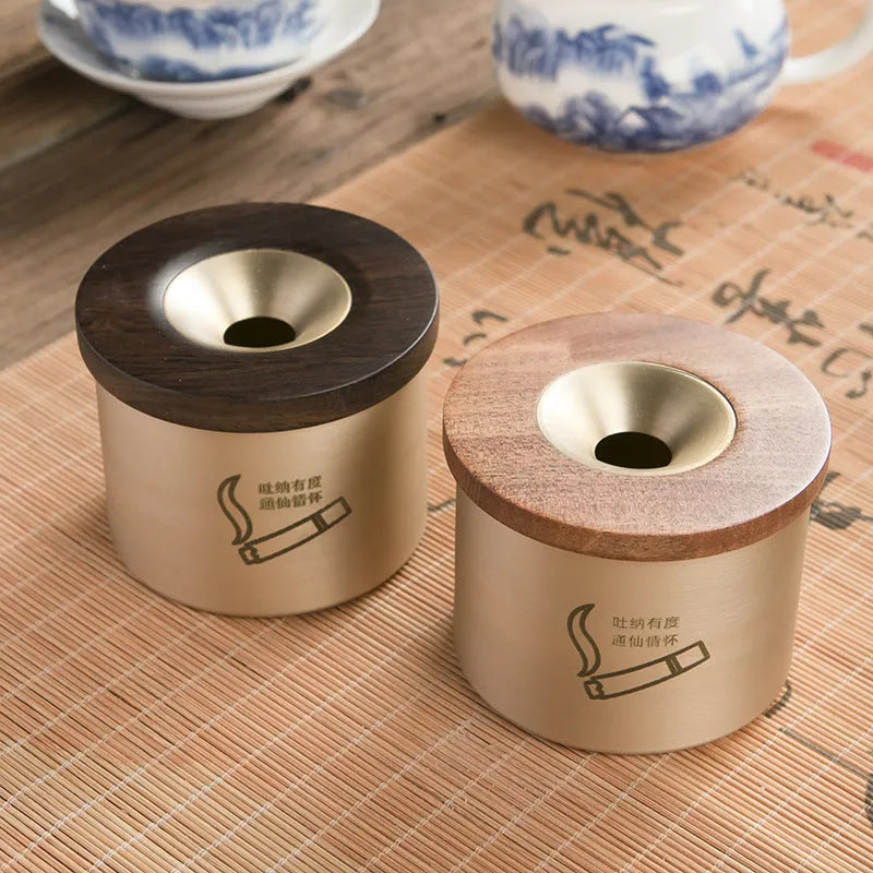 Retro brass ashtray with wooden lid showing copper construction and central hole design