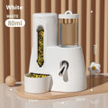 White plastic automatic water feeder with food basin for a hamster cage.