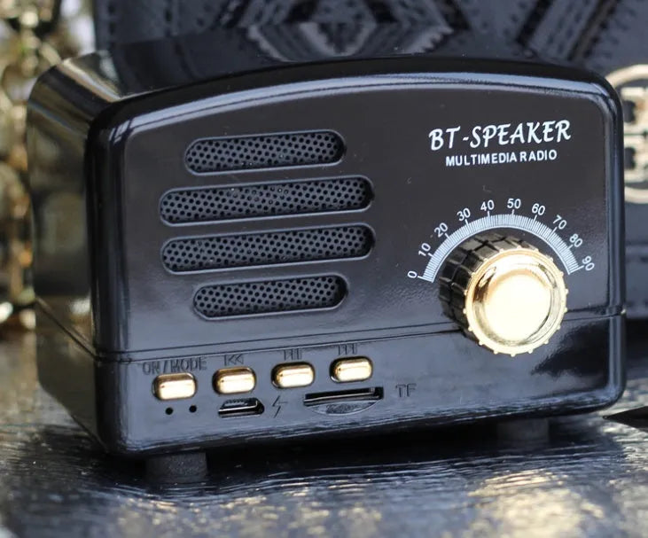 Wood grain finish bluetooth speaker showing compact design with USB charging port