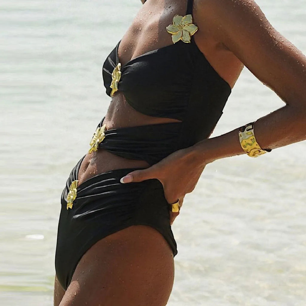 Women's solid colour one-piece swimsuit with a short skirt and hollow-out tube top design.