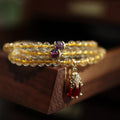 Natural gold rutilated quartz bracelet with three rings Chinese style design on wrist