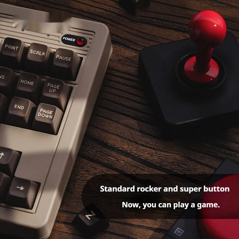 Retro87 C64 wireless Bluetooth mechanical keyboard with rocker on a desk.